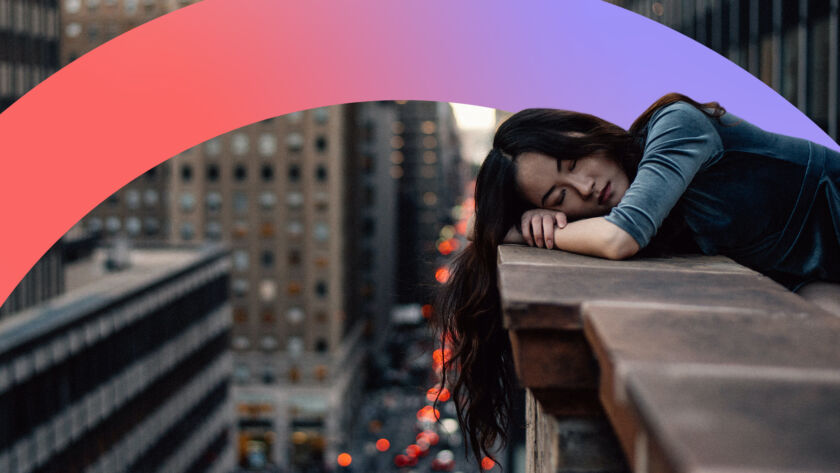 Women resting on a ledge looking sad.