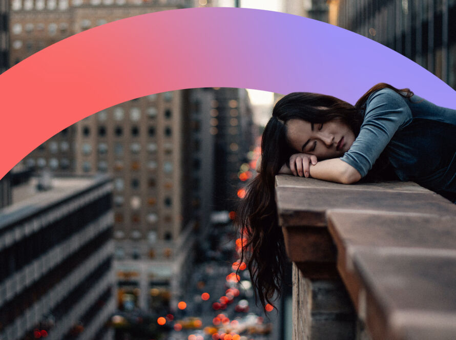 Women resting on a ledge looking sad.