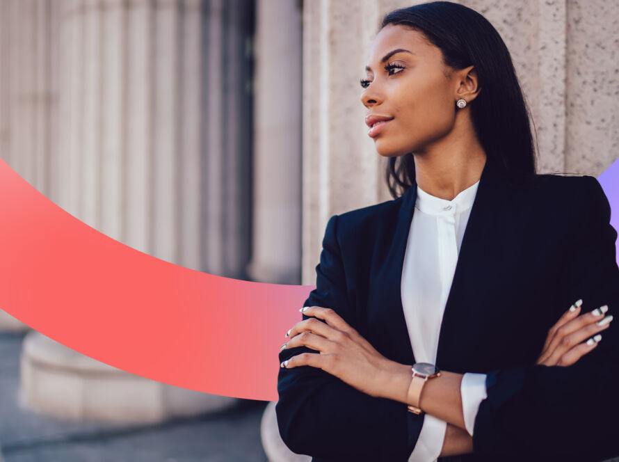 Woman looking away from camera in a suit, crossing her arms.