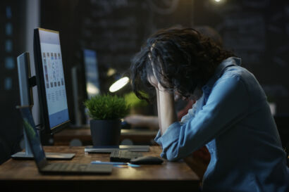 Woman looking frustrated at desk