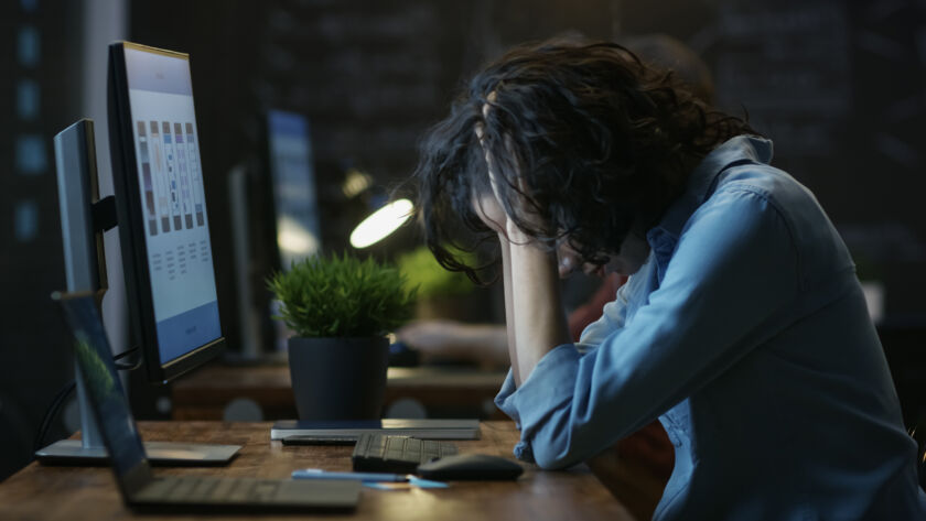 Woman looking frustrated at desk