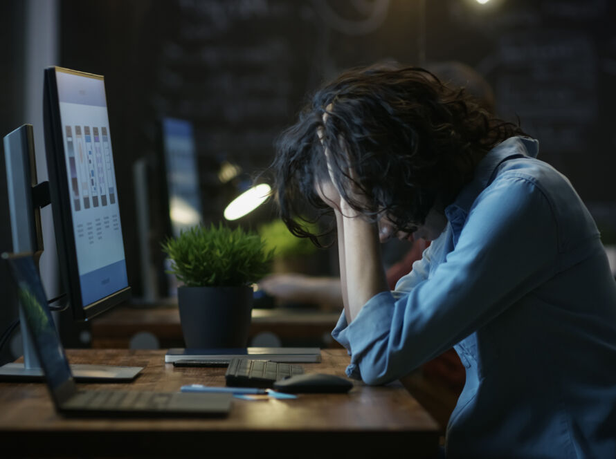 Woman looking frustrated at desk