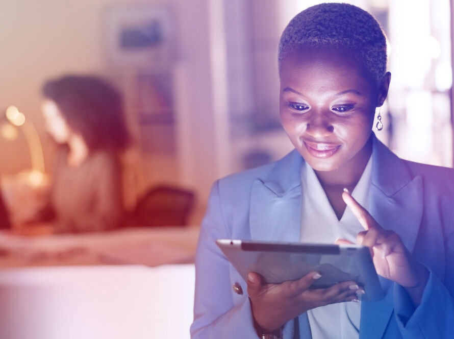 Woman smiling looking at a tablet.