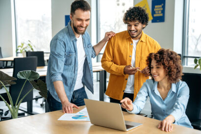 Group of people looking at a laptop