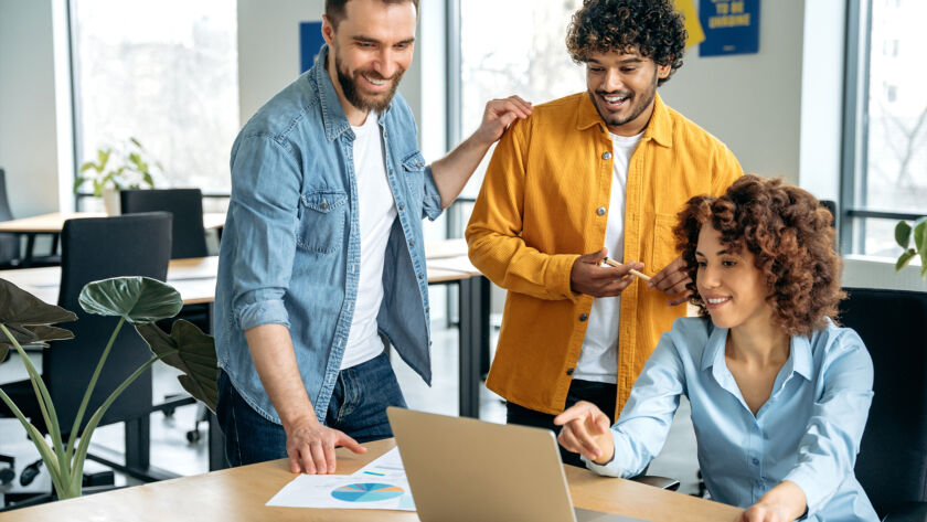 Group of people looking at a laptop