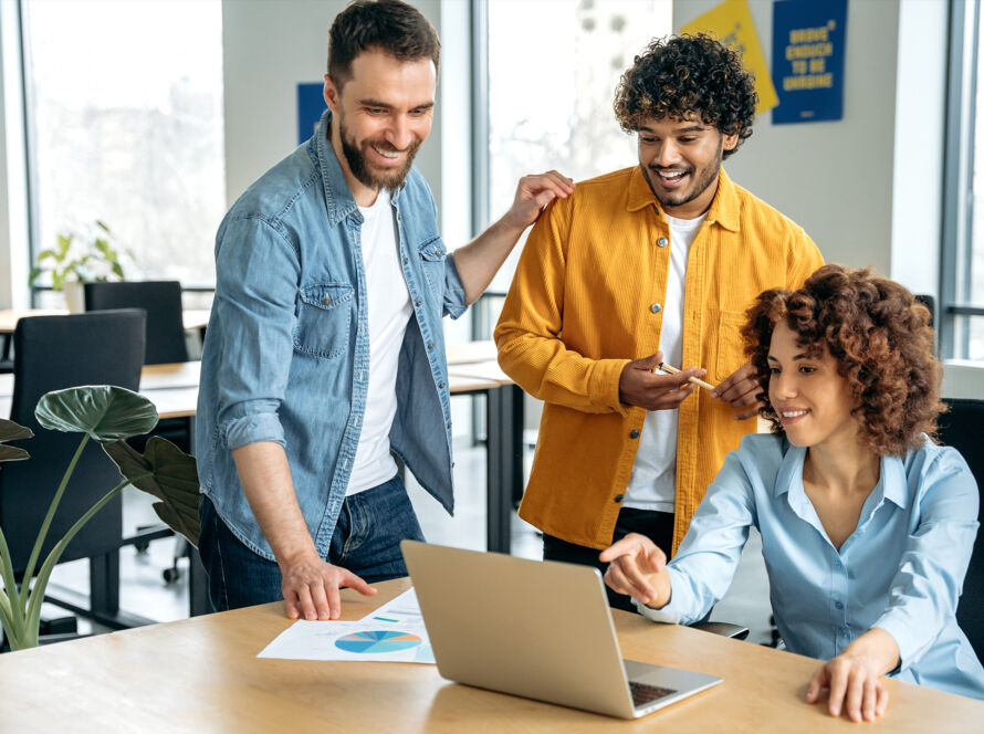 Group of people looking at a laptop